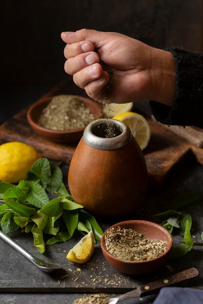 High angle person putting herbs in infuser