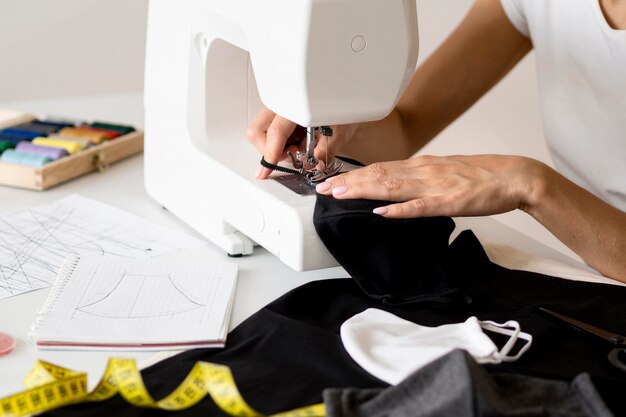 High angle of person sewing face mask