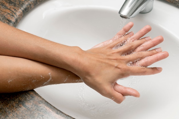 High angle person washing hands