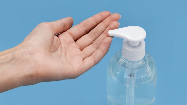 high angle person washing his hand with liquid soap