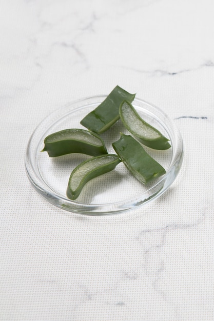 High angle of pieces of aloe vera on marble background