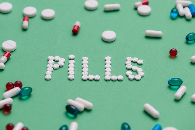 High angle pills on green background