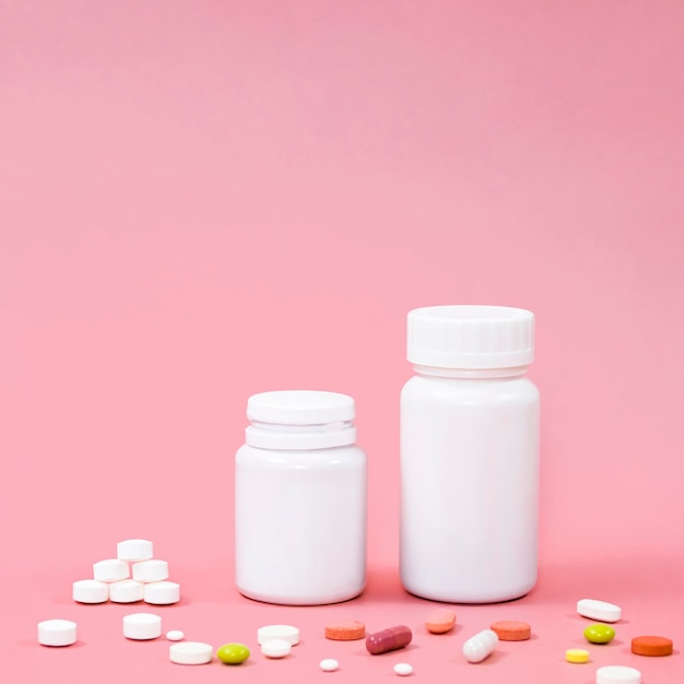 High angle of pills with containers and copy space