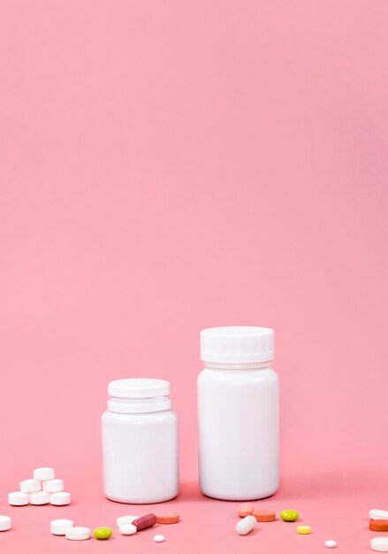 High angle of pills with copy space and containers