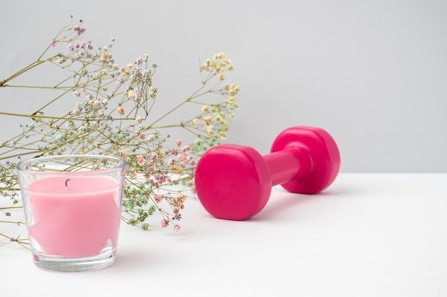 High angle pink candle and dumbbell