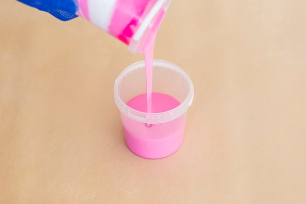 Free photo high angle of pink paint on plain background