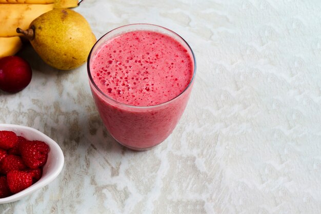 High angle pink smoothie in glass