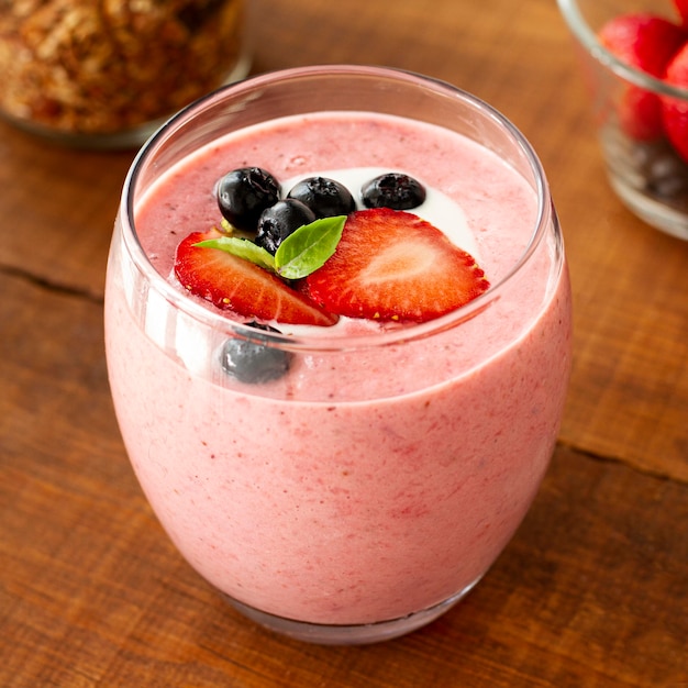 High angle pink yogurt with fruits