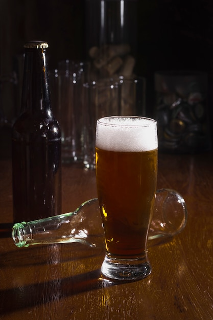 High angle pint with foam beer on table