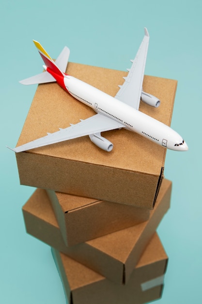 Free photo high angle plane on cardboard boxes