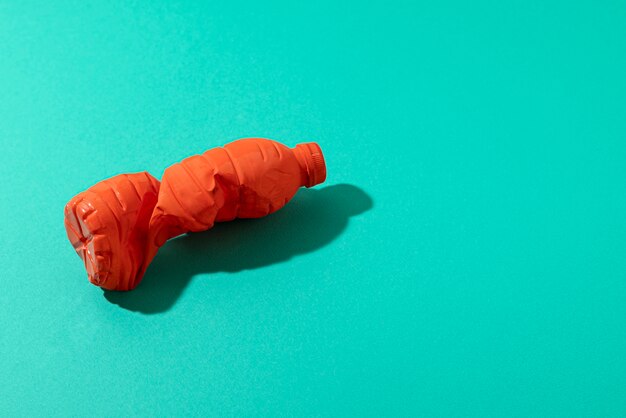 High angle plastic bottle on green background