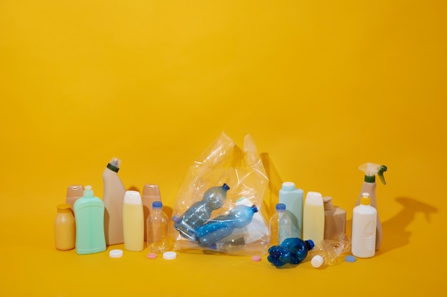 High angle plastic bottles on yellow background