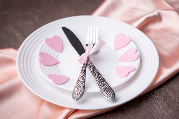 Free photo high angle of  plate with hearts and cutlery