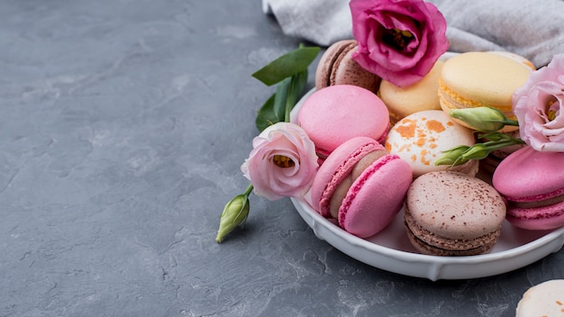 High angle of plate with roses and macarons