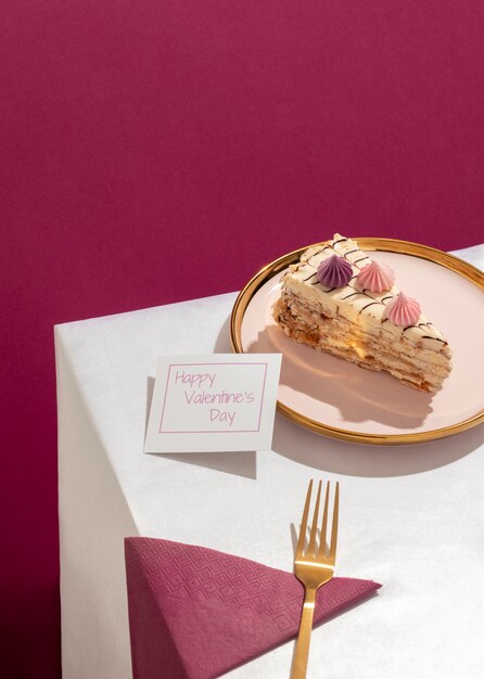 High angle of plate with slice of cake and fork for valentine's day