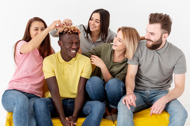 Free photo high angle playful young friends on couch