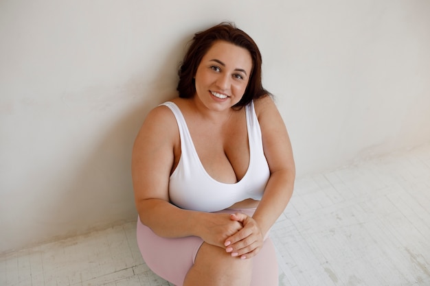 High angle plus size woman posing in studio