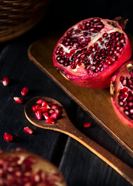 High angle of pomegranate fruit with wooden spoon