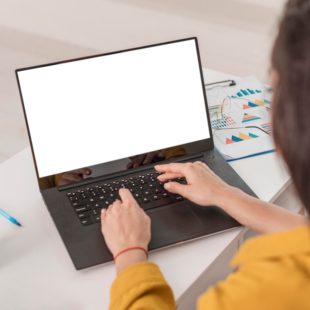 High angle of pregnant businesswoman working on laptop