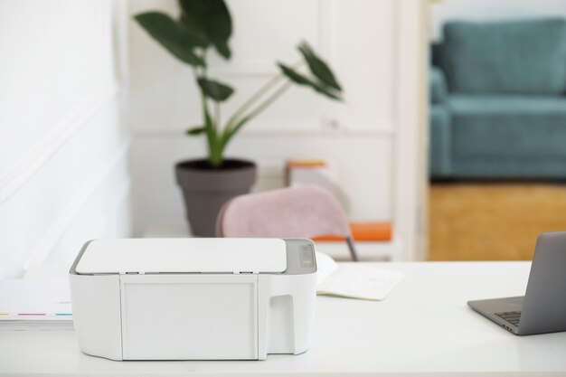 High angle printer and laptop on desk