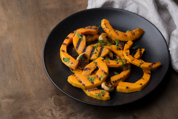 High angle pumpkin cooked arrangement on dark plate