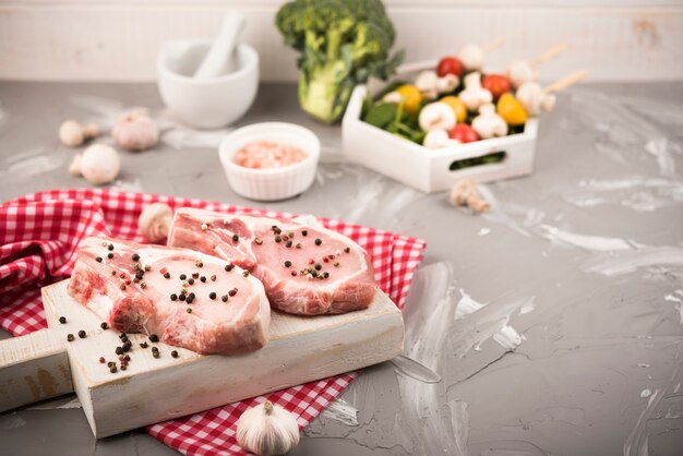 High angle raw steaks with veggies