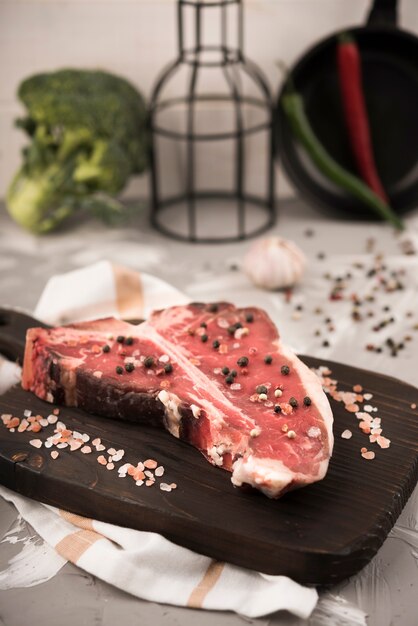 High angle raw t-bone steak and ingredients in kitchen