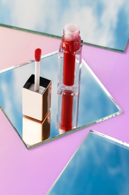 Free photo high angle red lip gloss on mirror