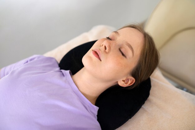 High angle relaxed woman laying in salon