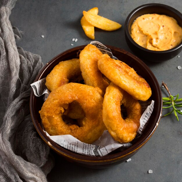 High angle of ring fries with mustard and herbs