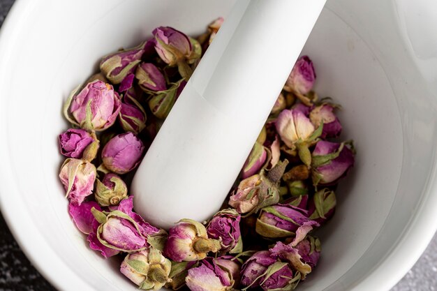 High angle of rose buds in mortar with pestle