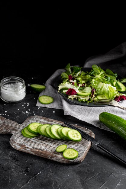 High angle salad arrangement with dark tableware