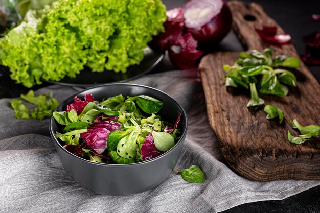 High angle salad with different ingredients on dark bowl