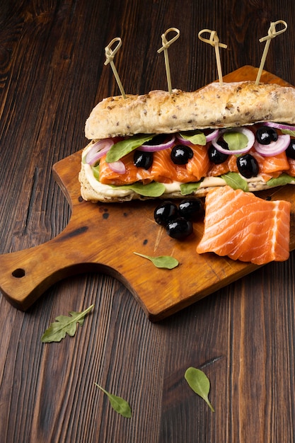 Free photo high angle of sandwich with salmon and olives