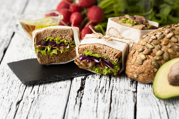 High angle of sandwiches on slate with avocado