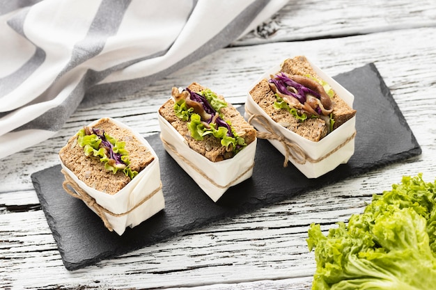 High angle of sandwiches on slate with salad