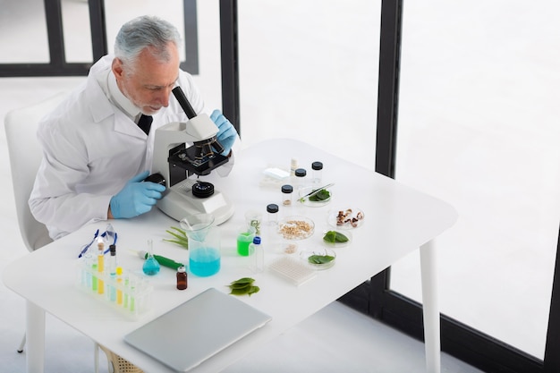 High angle scientist working with microscope Premium Photo
