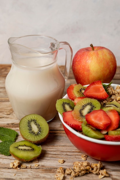 High angle of selection of breakfast cereals in bowl with milk and fruits