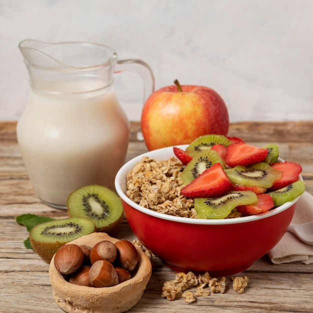 High angle of selection of breakfast cereals in bowl with milk and fruits