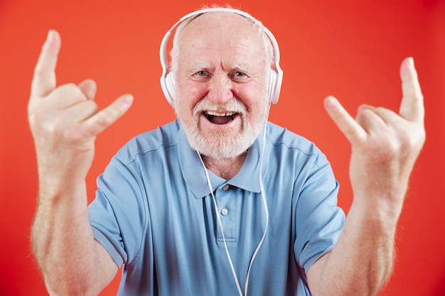 High angle senior enjoying music