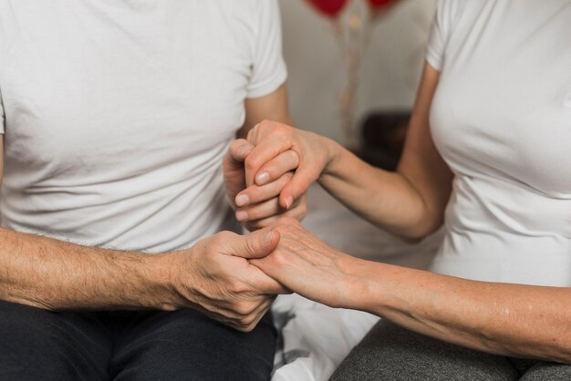 High angle senior holding hands