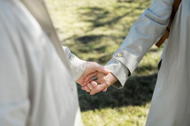 Free photo high angle senior people holding hands