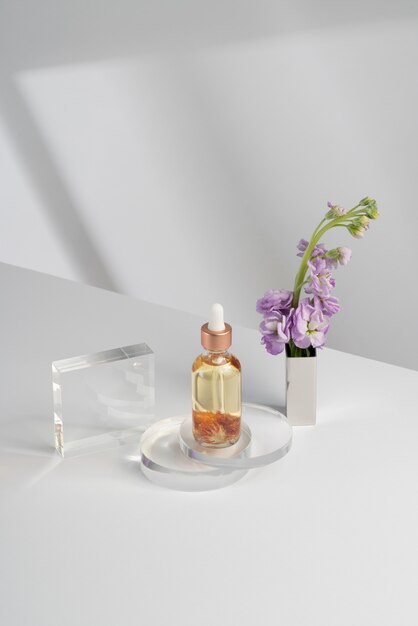 High angle serum bottle and flower
