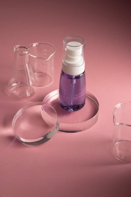 High angle serum bottle and lab glasses