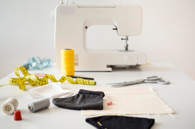 High angle of sewing machine with measuring tape and face masks