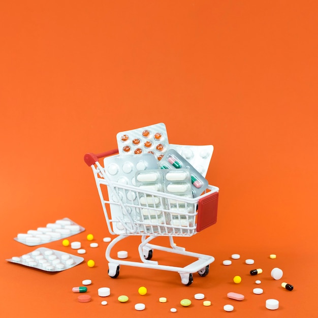 High angle of shopping cart with pill foils and copy space