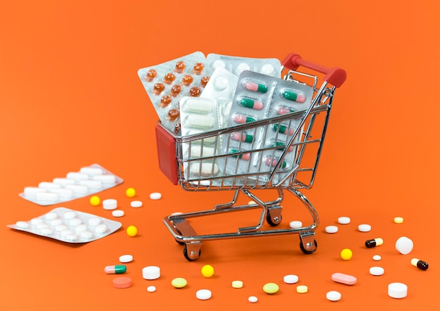 Free photo high angle of shopping cart with pill foils