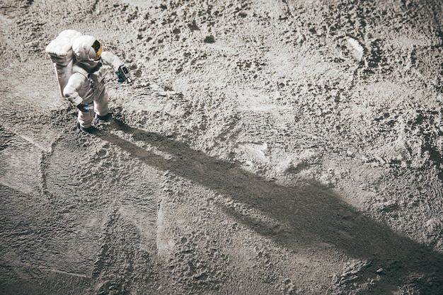 High angle shot of an astronaut miniature toy on the moon