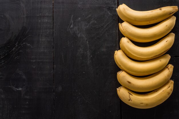 High angle shot of bananas with a copy space on a black background