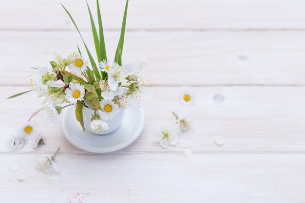 High angle shot of beautiful daises put in a white cup